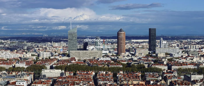 Panoramic city view of Vienna with Directions for Partners branding overlay.